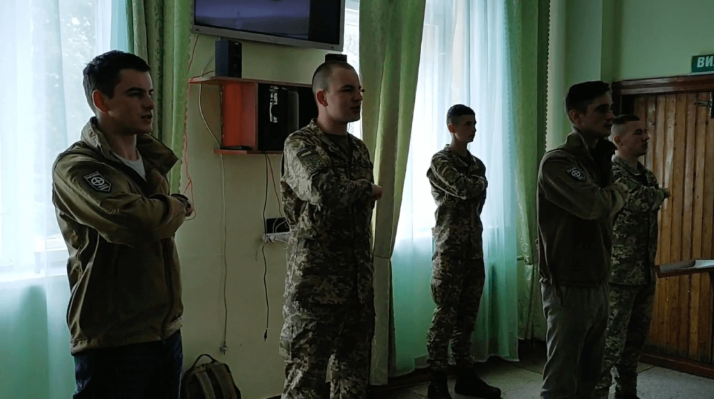12 A still from the video posted to Centuria’s Telegram shows the individuals leading NAA cadets in the “Prayer of the Ukrainian Nationalist.” From left Yuriy Gavrylyshyn, I