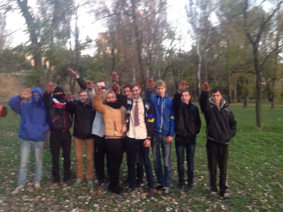 60 Photo of Danylo Tikhomirov (center, wearing a tie) in a group of about a dozen young people making Nazi salutes that was posted to his VK in 2016